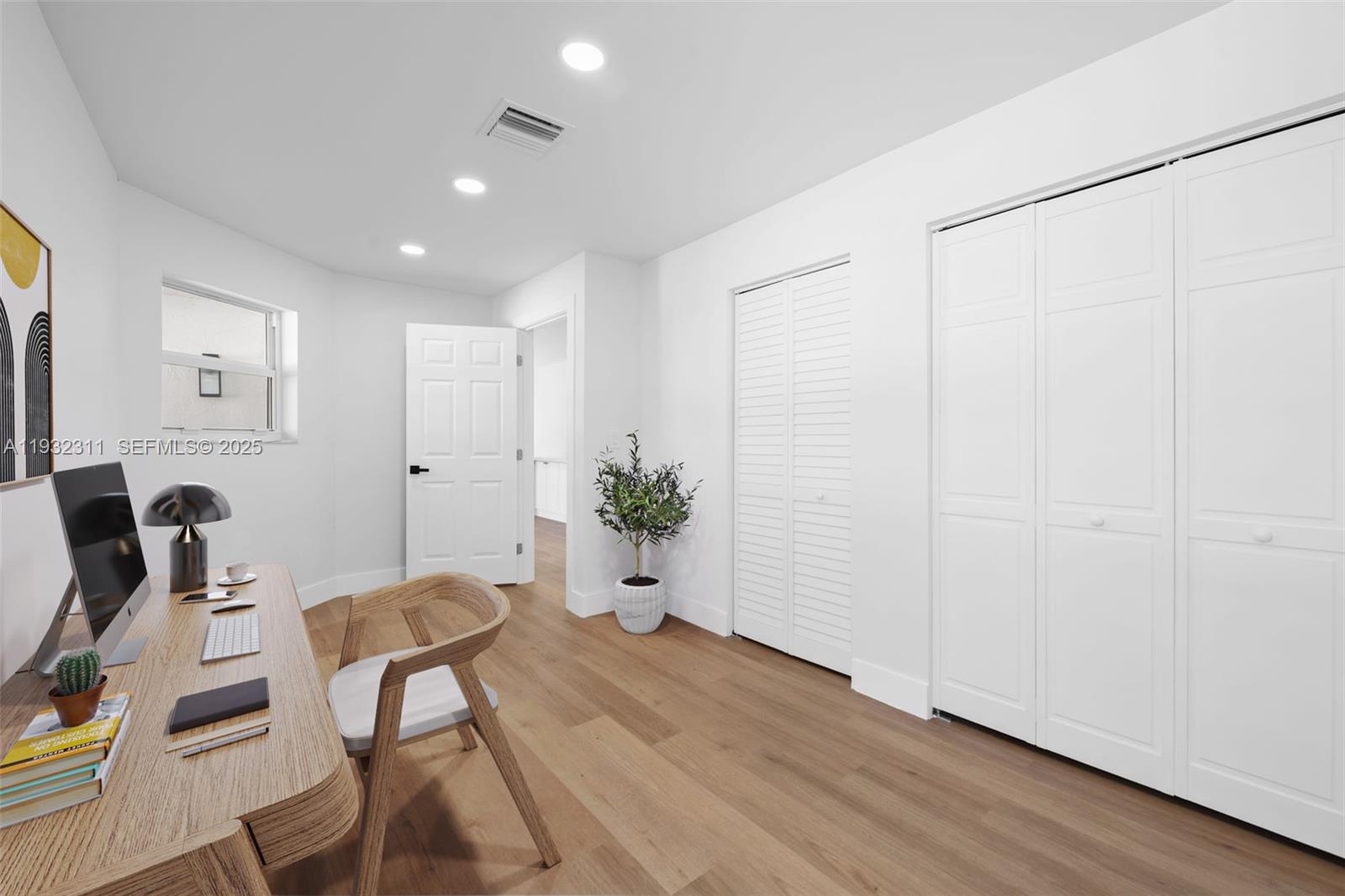 2014 Northwest 52nd Street Boca Raton, FL 33496 - Photo 18 of 26 a view of a workspace with furniture and wooden floor