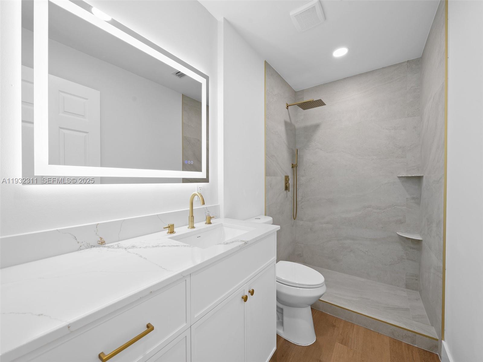 2014 Northwest 52nd Street Boca Raton, FL 33496 - Photo 19 of 26 a bathroom with a sink a toilet and shower