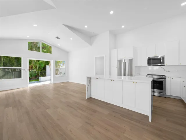a view of kitchen with stainless steel appliances refrigerator oven and stove