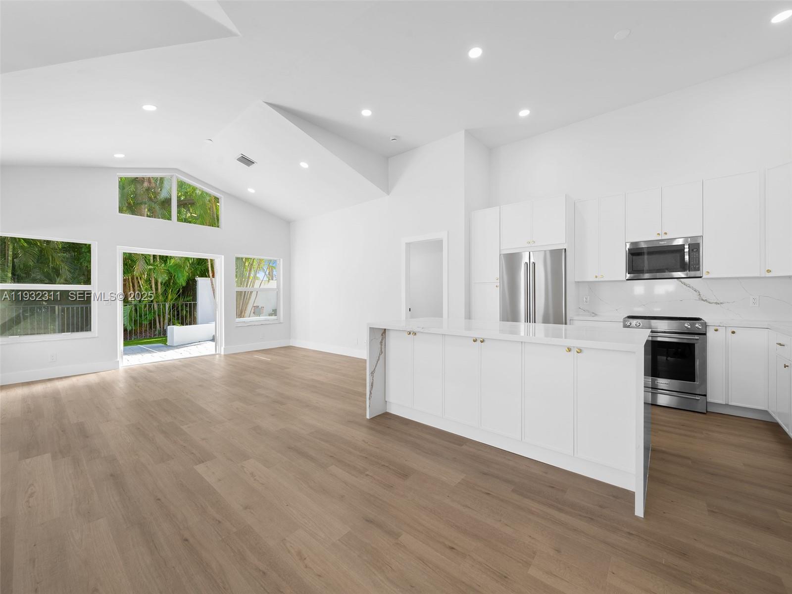 2014 Northwest 52nd Street Boca Raton, FL 33496 - Photo 3 of 26 a view of kitchen with stainless steel appliances refrigerator oven and stove