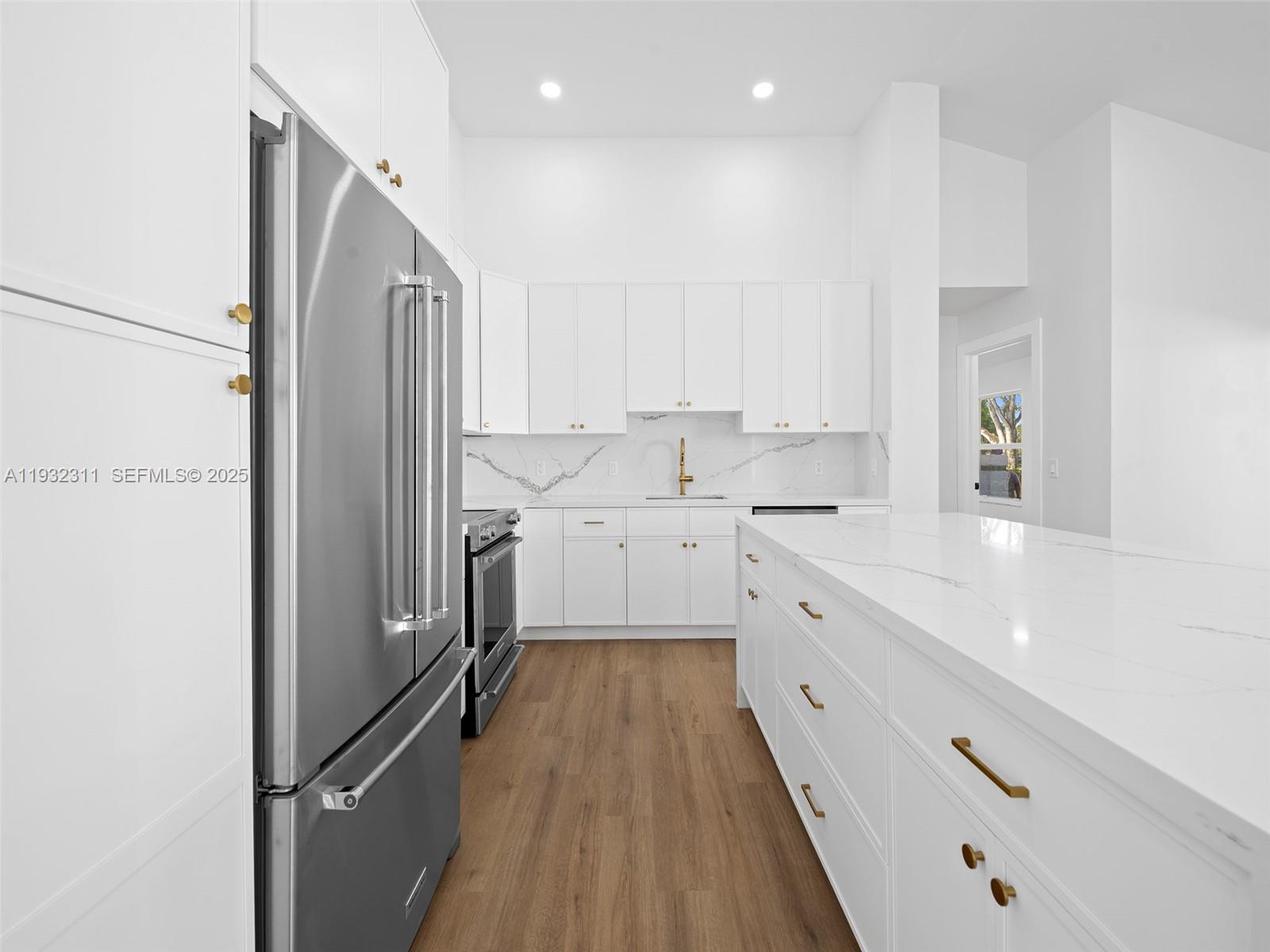 2014 Northwest 52nd Street Boca Raton, FL 33496 - Photo 6 of 26 a large white kitchen with a large window