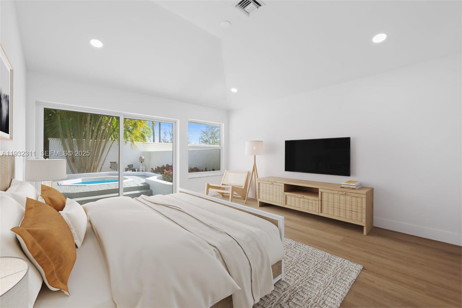 2014 Northwest 52nd Street Boca Raton, FL 33496 - Photo 8 of 26 a bedroom with a bed and a flat screen tv