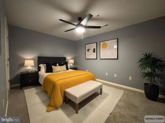 a bedroom with a bed and potted plant