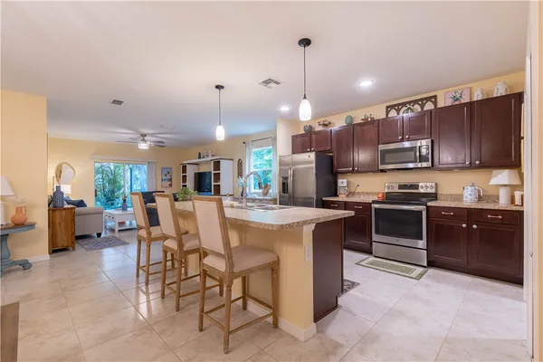 a kitchen with stainless steel appliances granite countertop a stove top oven a sink a counter top space and cabinets