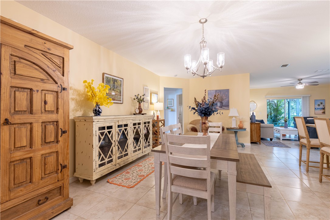 898 Lorca Avenue Sebastian, FL 32958 - Photo 12 of 36 a view of a dining room with furniture a chandelier and wooden floor
