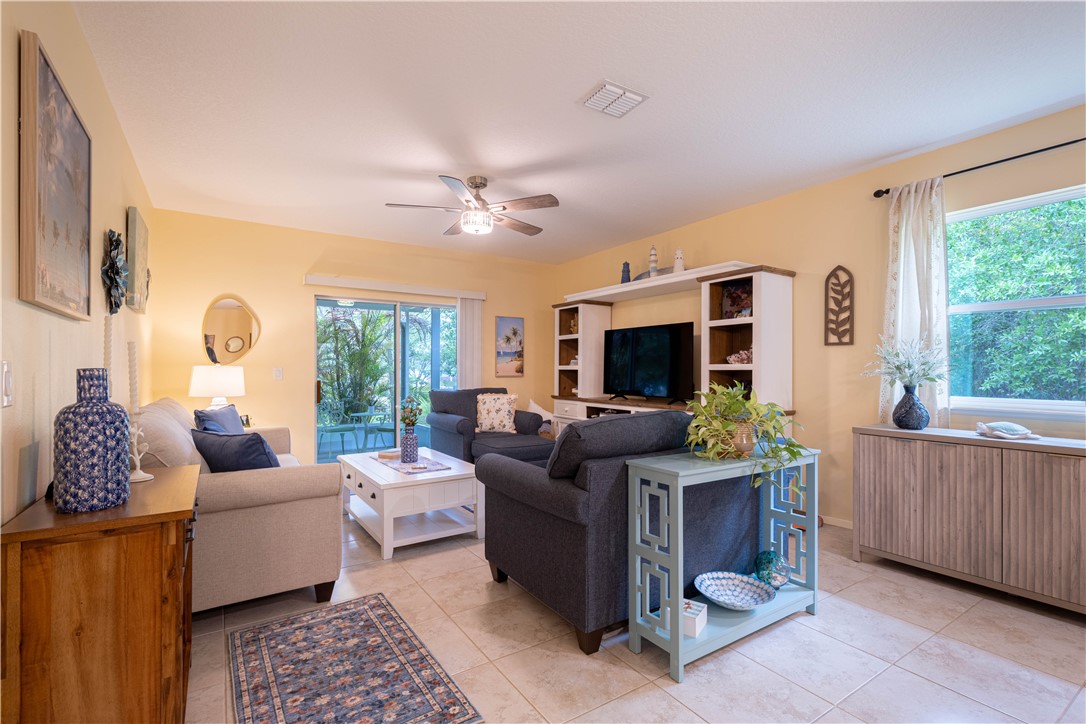 898 Lorca Avenue Sebastian, FL 32958 - Photo 23 of 36 a living room with furniture a flat screen tv and a large window