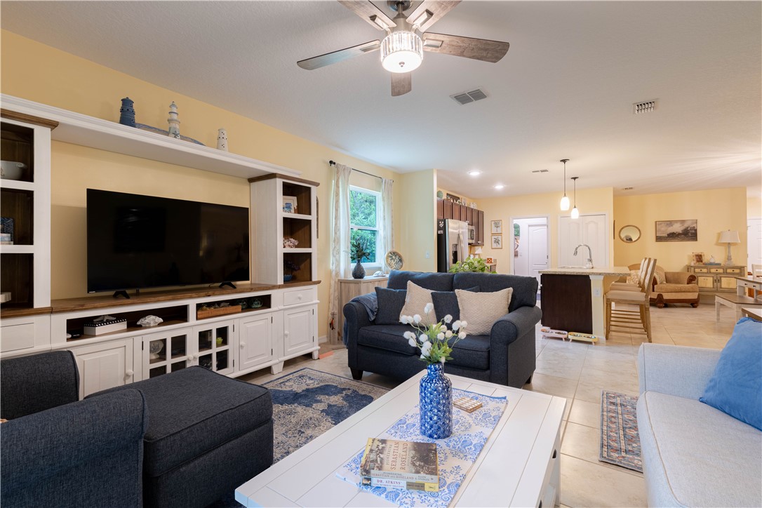 898 Lorca Avenue Sebastian, FL 32958 - Photo 24 of 36 a living room with furniture and a flat screen tv