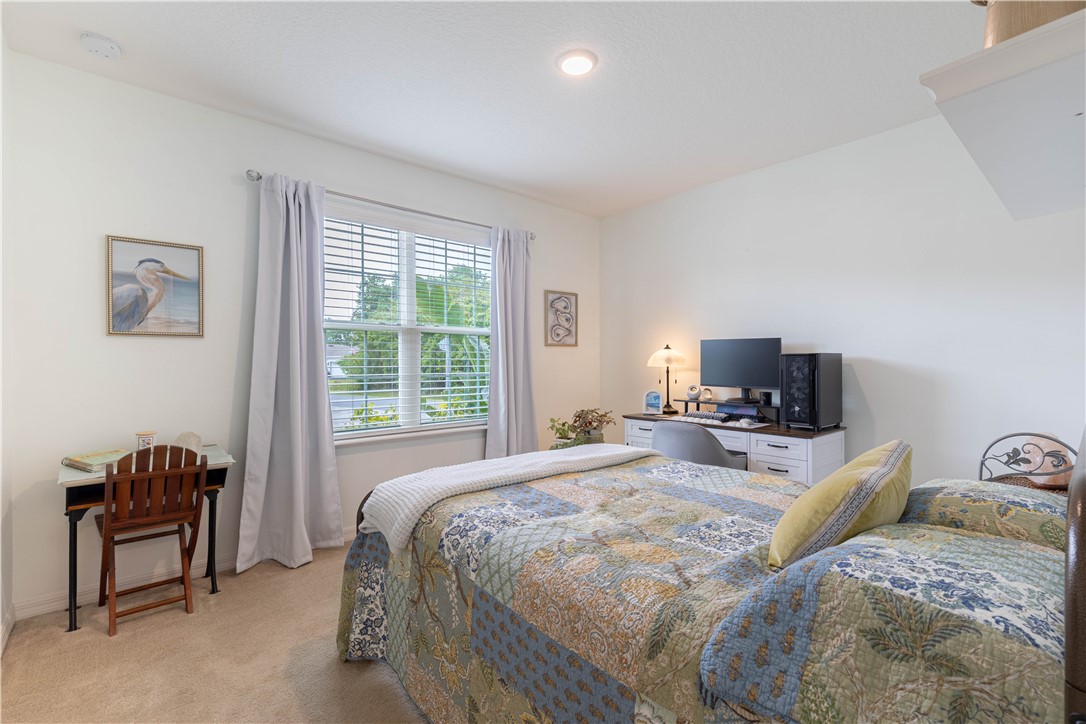 898 Lorca Avenue Sebastian, FL 32958 - Photo 28 of 36 a bedroom with a bed and a couch