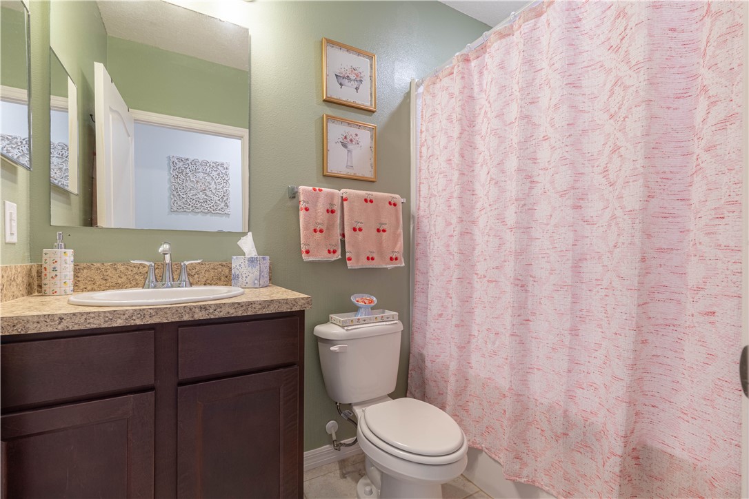 898 Lorca Avenue Sebastian, FL 32958 - Photo 29 of 36 a bathroom with a granite countertop sink mirror vanity and toilet