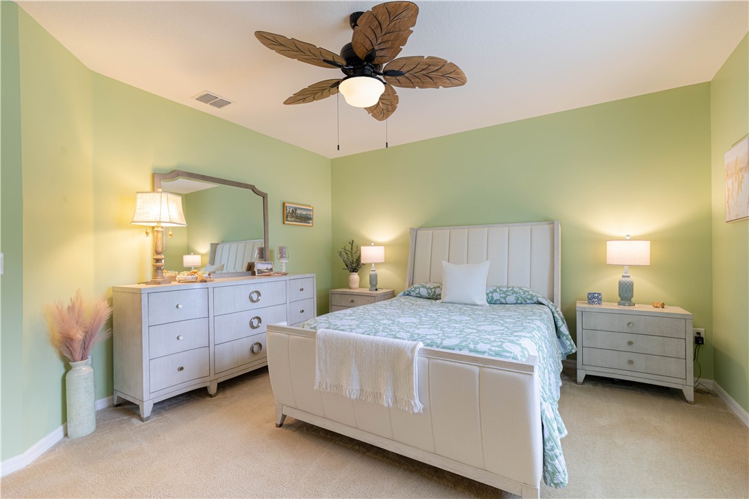 898 Lorca Avenue Sebastian, FL 32958 - Photo 32 of 36 a bedroom with a bed and cabinets