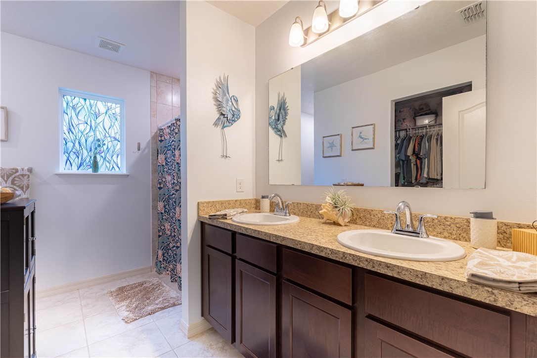 898 Lorca Avenue Sebastian, FL 32958 - Photo 33 of 36 a bathroom with a granite countertop sink and a mirror