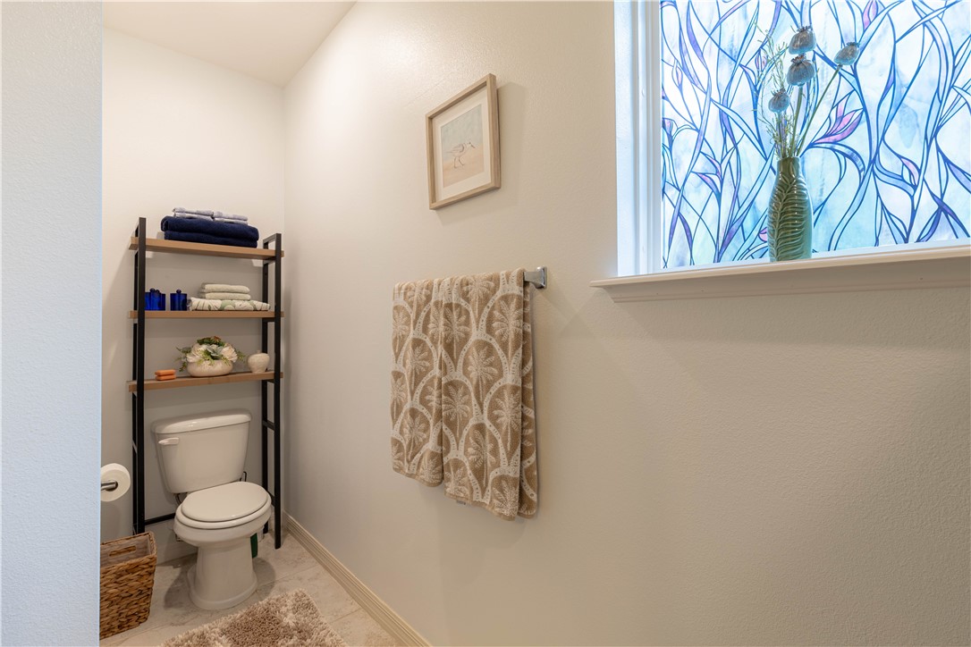 898 Lorca Avenue Sebastian, FL 32958 - Photo 34 of 36 a bathroom with a toilet and a shower curtain