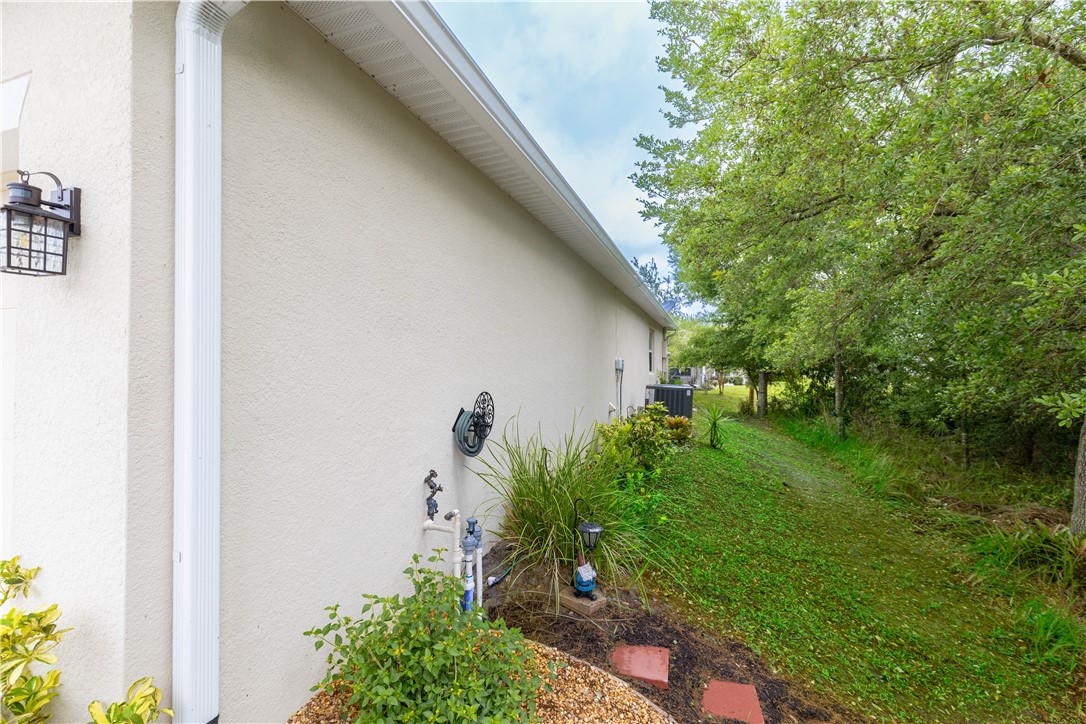 898 Lorca Avenue Sebastian, FL 32958 - Photo 5 of 36 a backyard of a house with plants and large tree