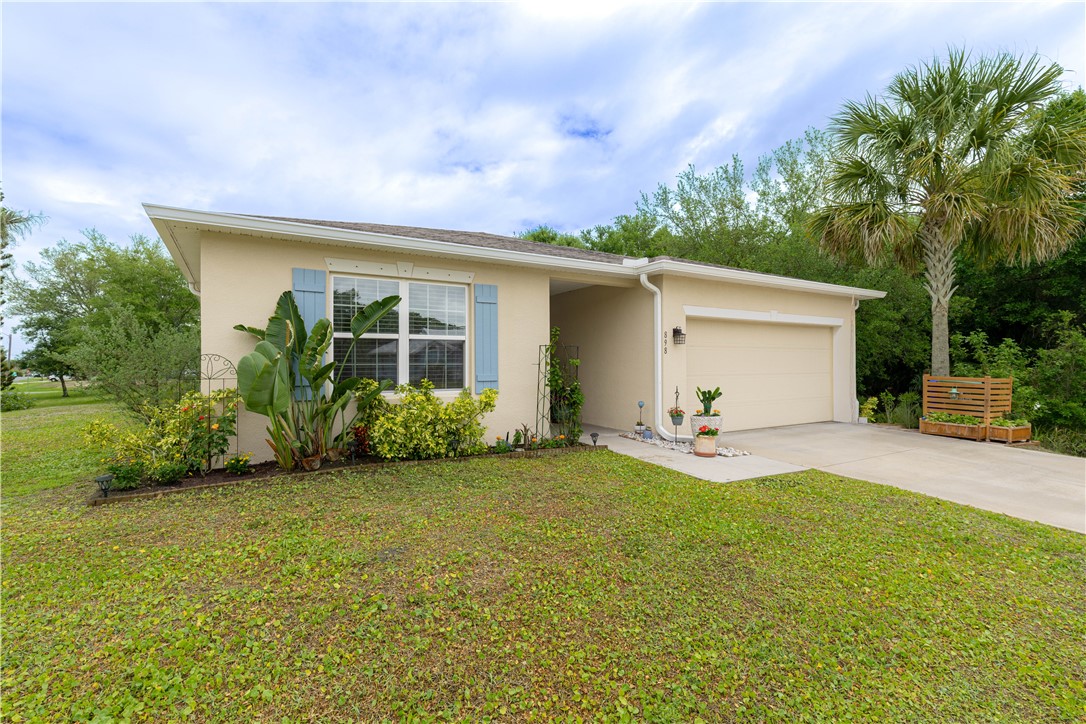 898 Lorca Avenue Sebastian, FL 32958 - Photo 7 of 36 a view of a house with a yard and garage