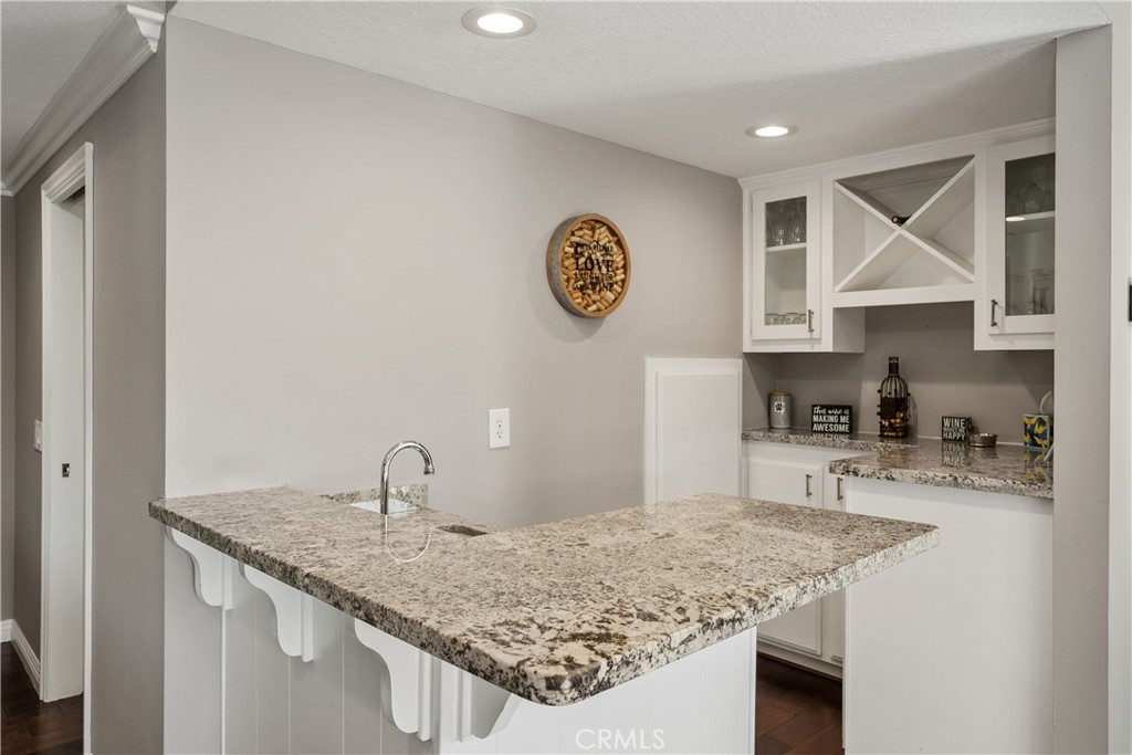31041 Augusta Drive Laguna Niguel, CA 92677 - Photo 14 of 35 a kitchen with granite countertop a sink a stove and cabinets