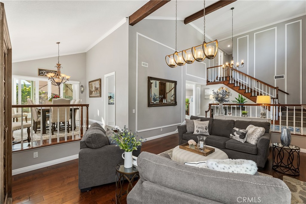 31041 Augusta Drive Laguna Niguel, CA 92677 - Photo 5 of 35 a living room with furniture a chandelier and a dining table
