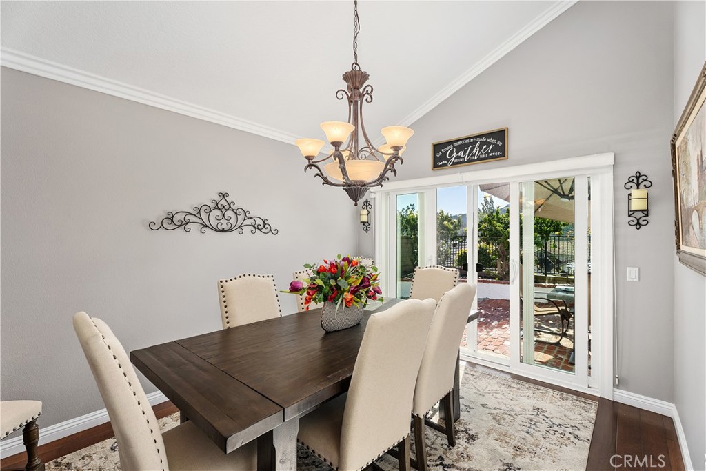 31041 Augusta Drive Laguna Niguel, CA 92677 - Photo 6 of 35 a dining room with furniture a chandelier and wooden floor