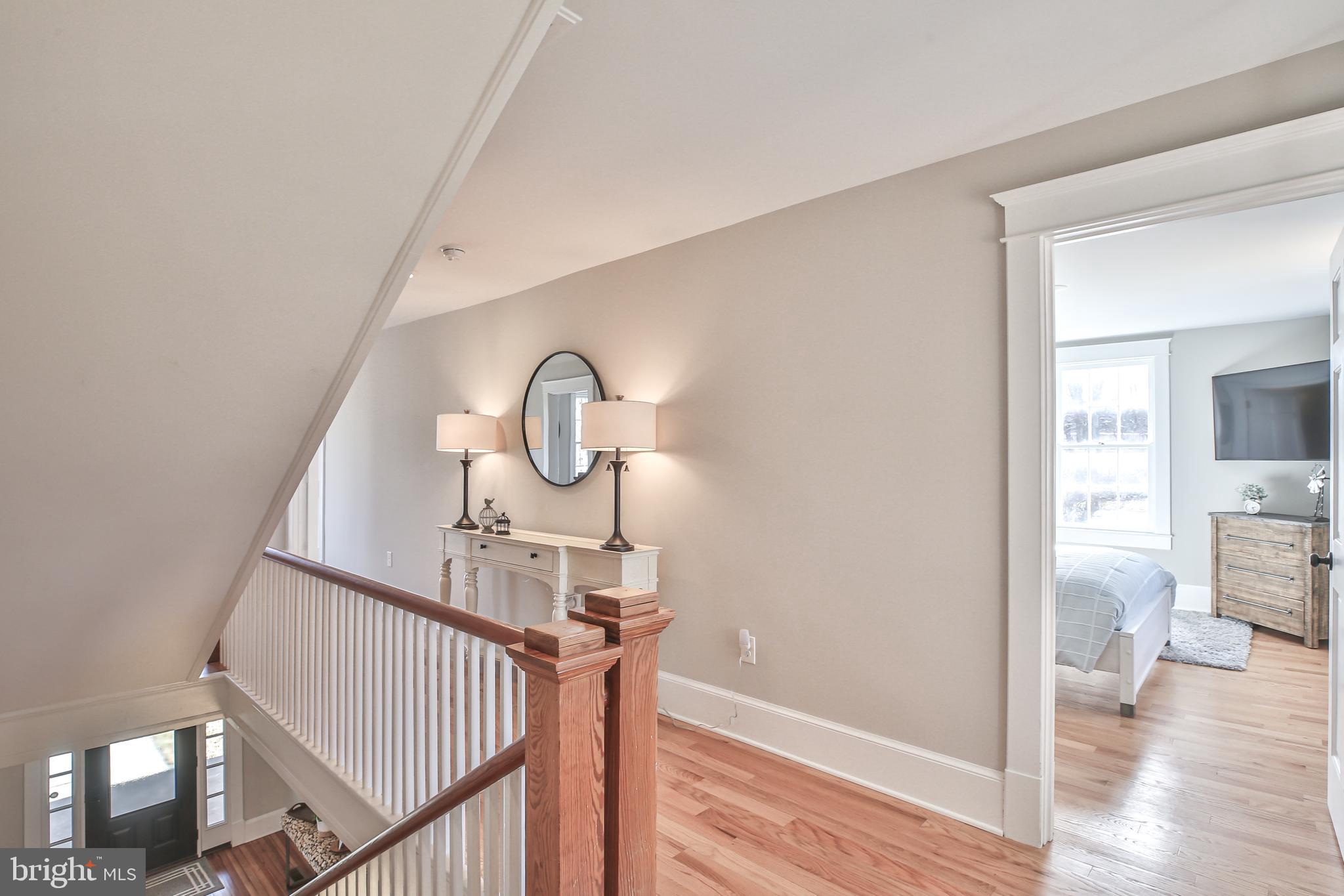 17345 Raven Rocks Road Bluemont, VA 20135 - Photo 58 of 99 a view of a hallway with wooden floor table and chairs