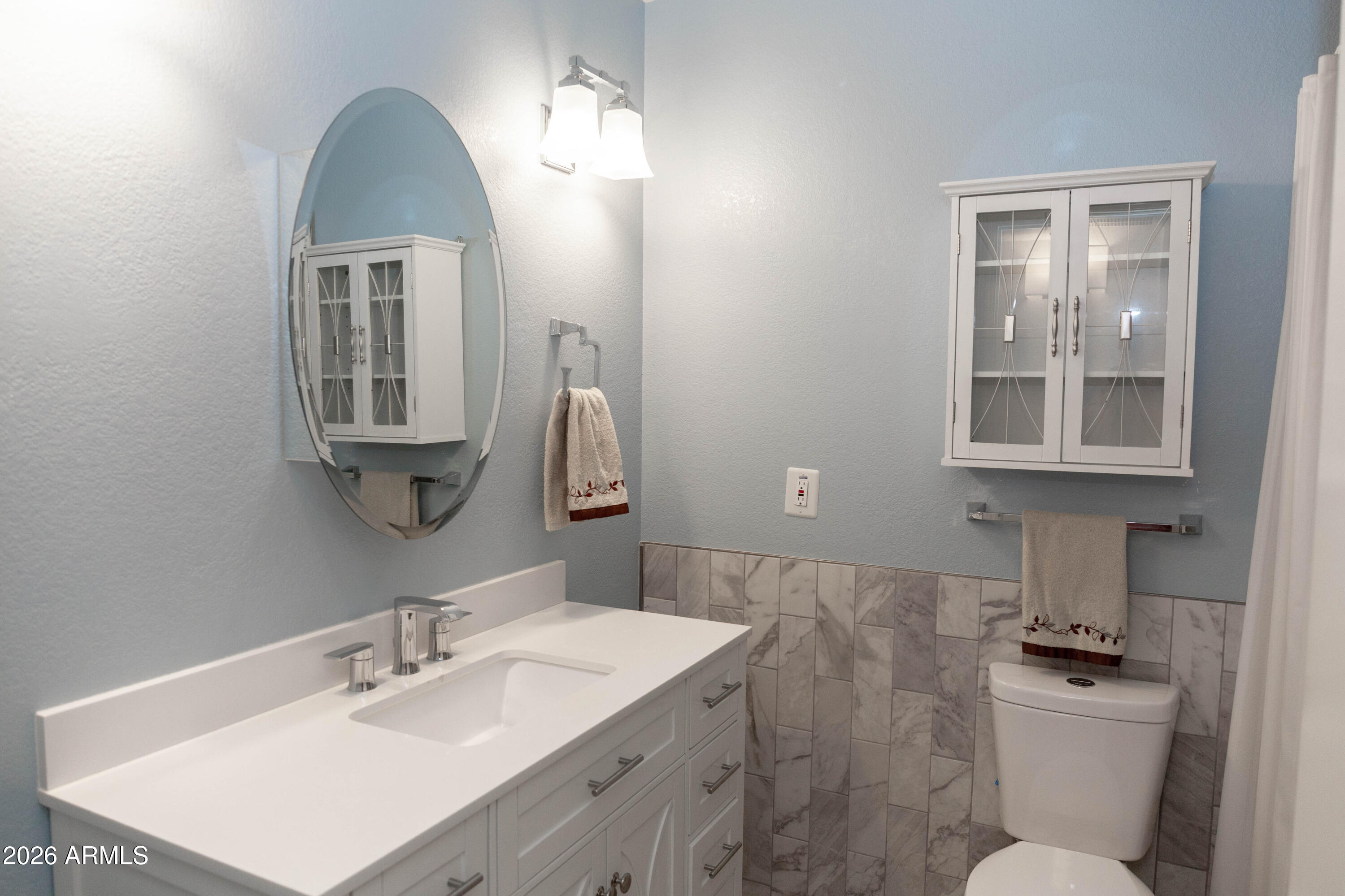 6544 East Dodge Street Mesa, AZ 85205 - Photo 13 of 22 a bathroom with a toilet sink and mirror