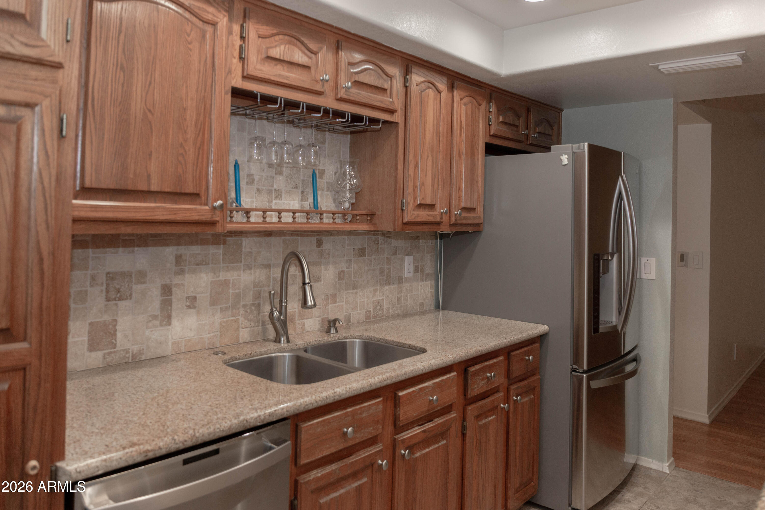 6544 East Dodge Street Mesa, AZ 85205 - Photo 7 of 22 a kitchen with stainless steel appliances granite countertop a refrigerator and a sink