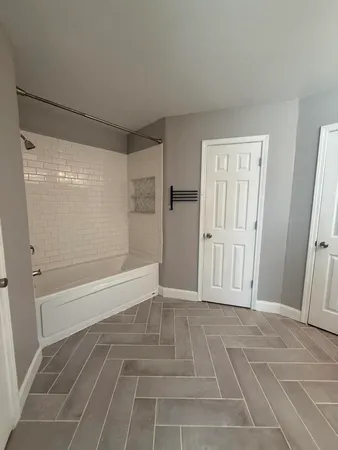 a bathroom with a glass door shower
