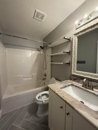 a bathroom with a sink toilet and shower