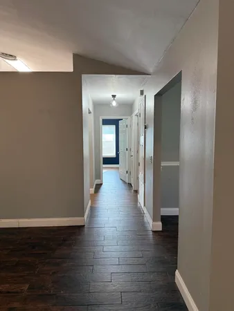 a view of a hallway with wooden floor