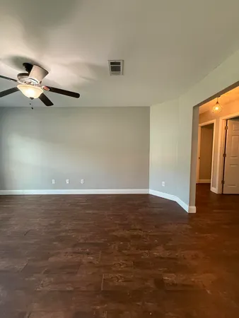 a view of a room with wooden floor