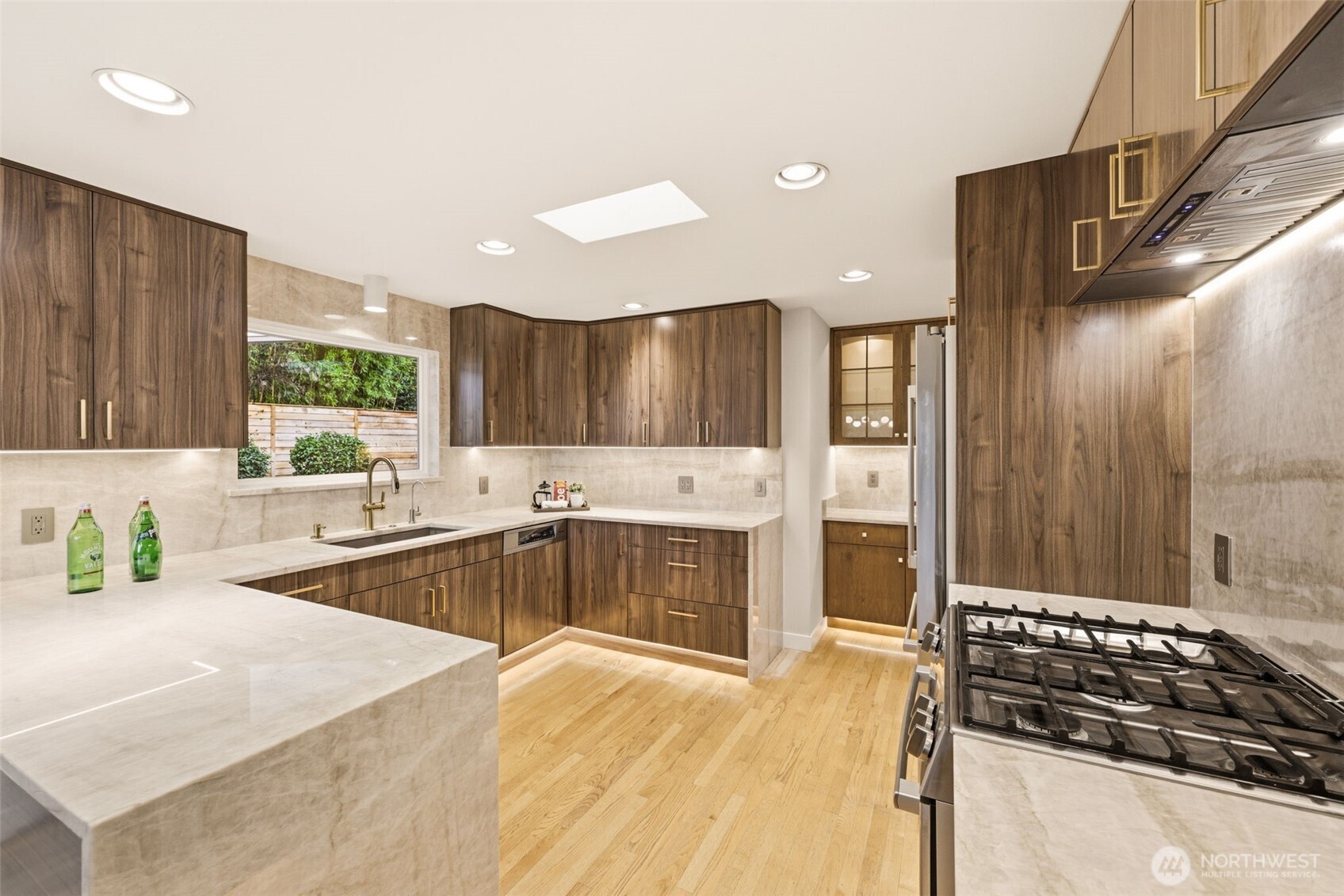 3601 Northeast 100th Street Seattle, WA 98115 - Photo 14 of 37 a large kitchen with stainless steel appliances a large counter top a stove and a refrigerator