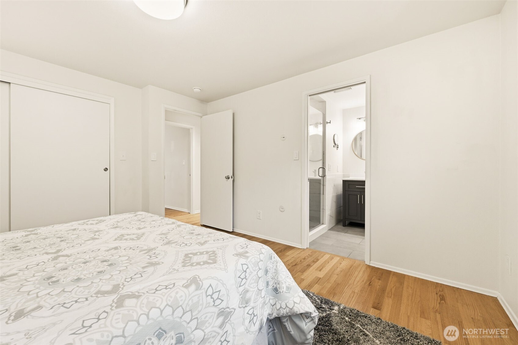 3601 Northeast 100th Street Seattle, WA 98115 - Photo 20 of 37 a bedroom with a bed and a mirror
