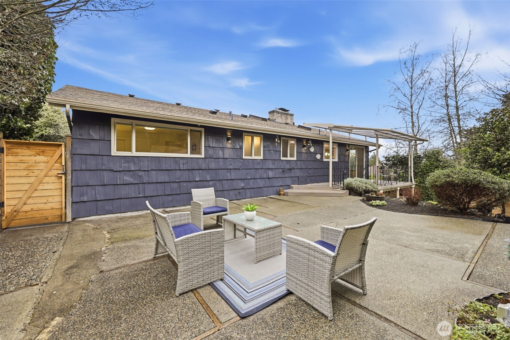 3601 Northeast 100th Street Seattle, WA 98115 - Photo 32 of 37 a view of a patio with table and chairs and potted plants