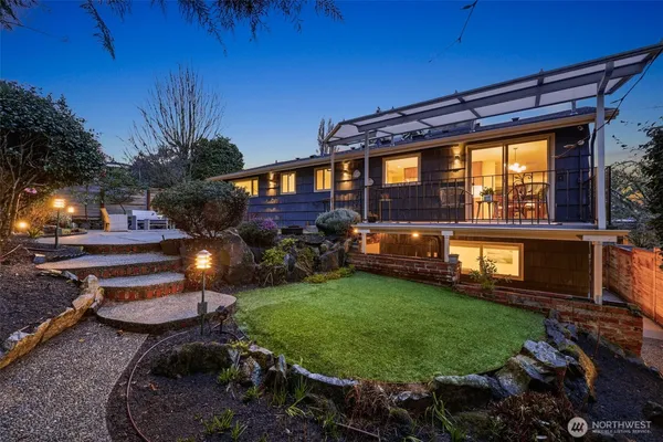 a backyard of a house with yard fire pit and outdoor seating