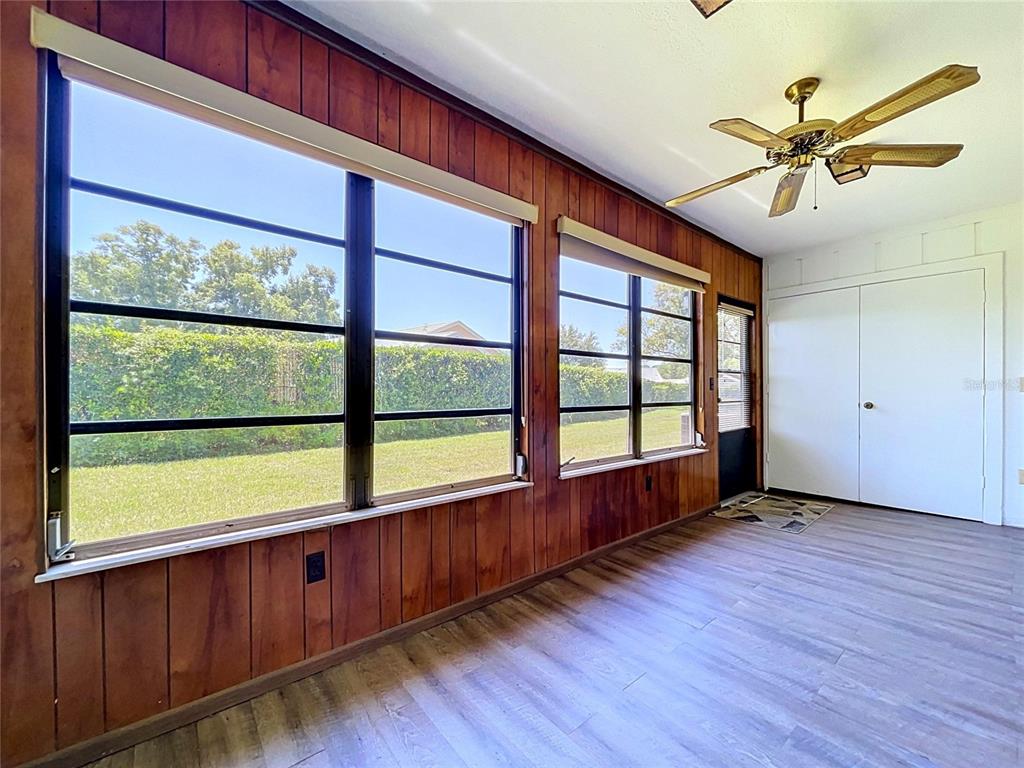 9319 Trowbridge Court New Port Richey, FL 34655 - Photo 35 of 78 a view of an empty room with wooden floor and a window