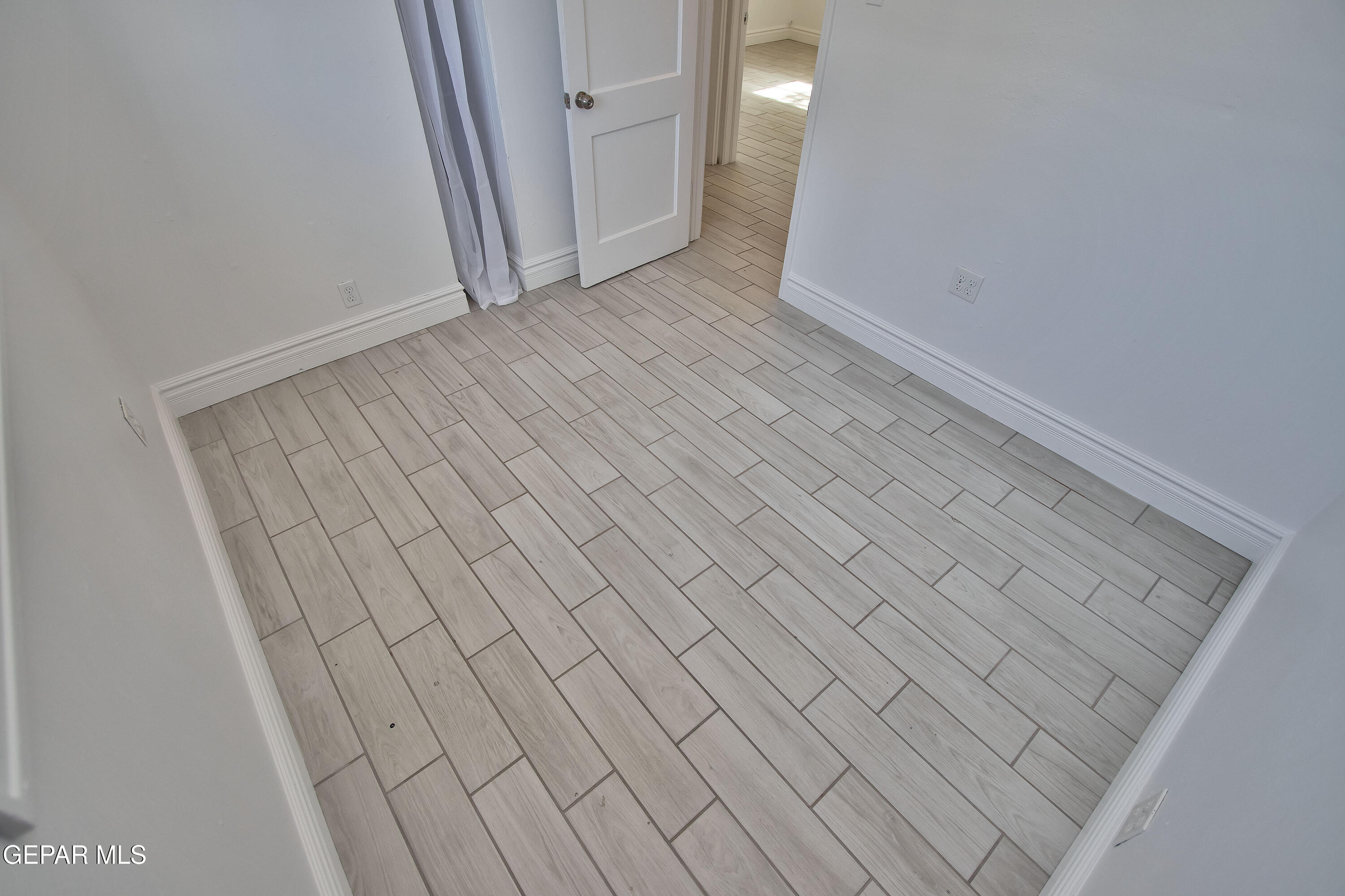 8415 Mt Ranier Drive El Paso, TX 79904 - Photo 34 of 69 wooden floor in a hall with an empty room