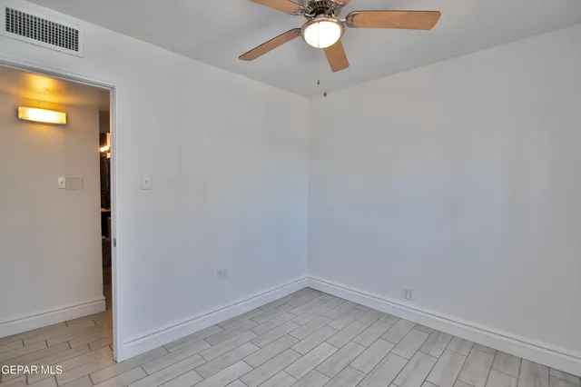 a view of walk in closet with empty racks