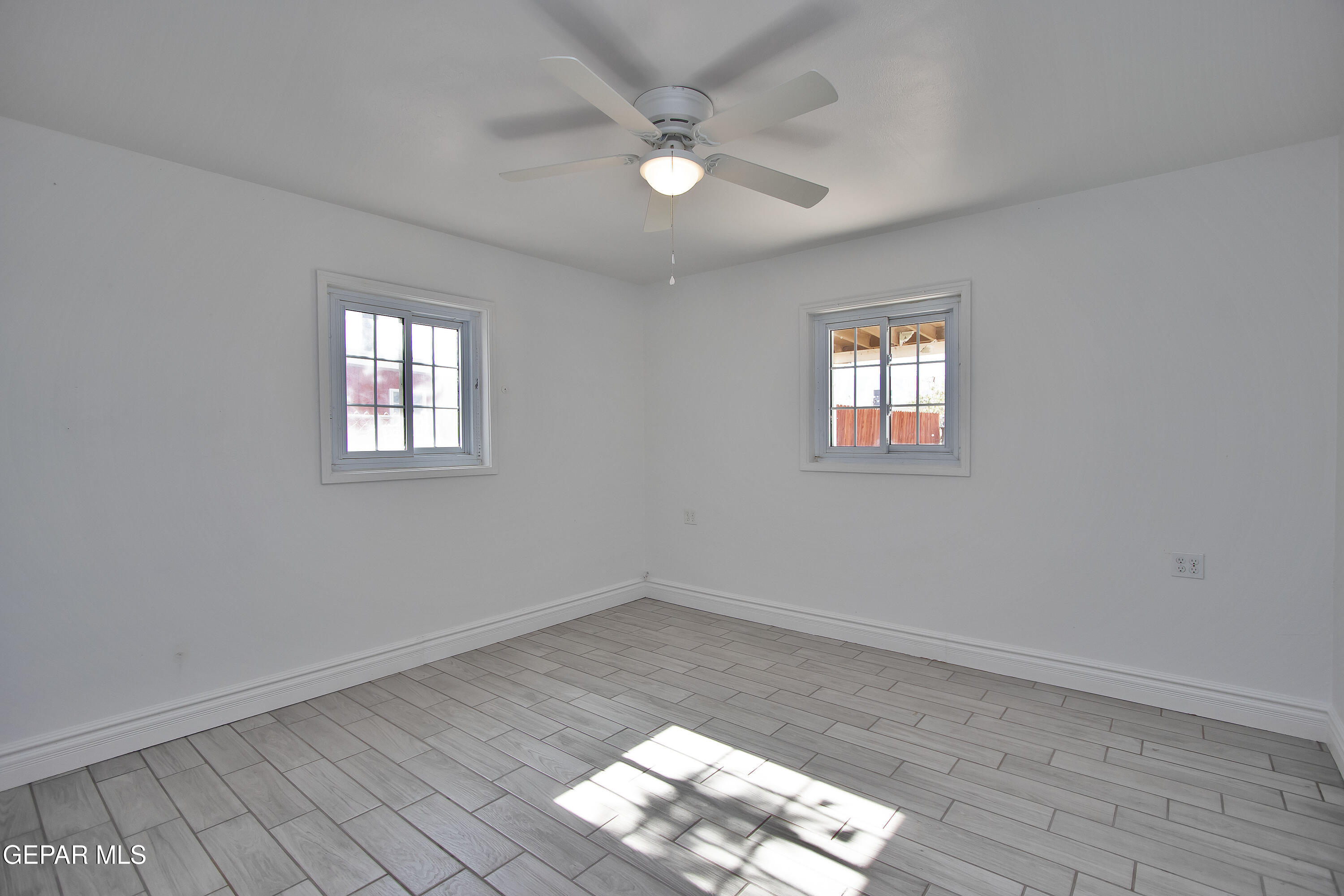 8415 Mt Ranier Drive El Paso, TX 79904 - Photo 37 of 69 wooden floor in an empty room with a window