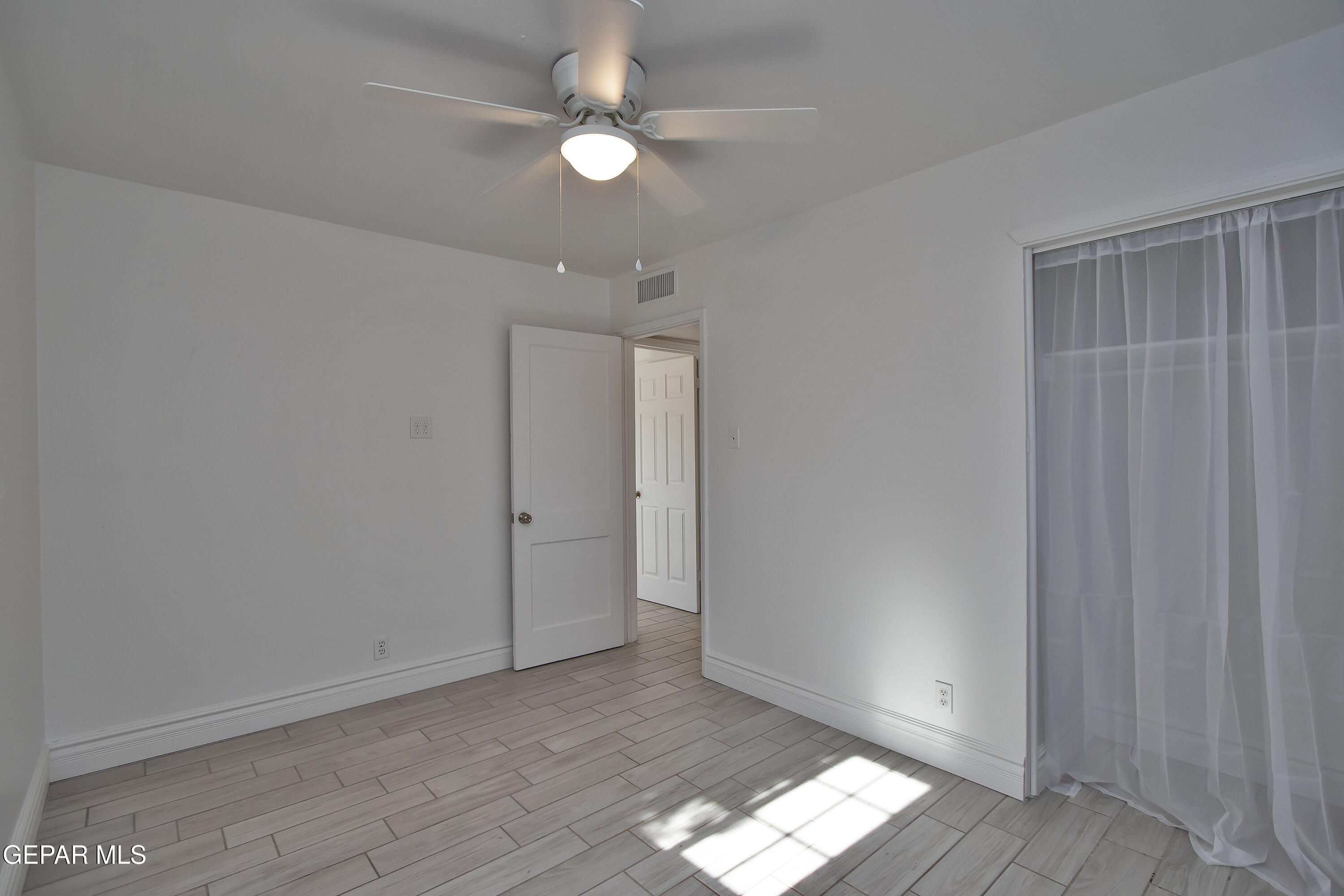 8415 Mt Ranier Drive El Paso, TX 79904 - Photo 42 of 69 wooden floor in an empty room with a window