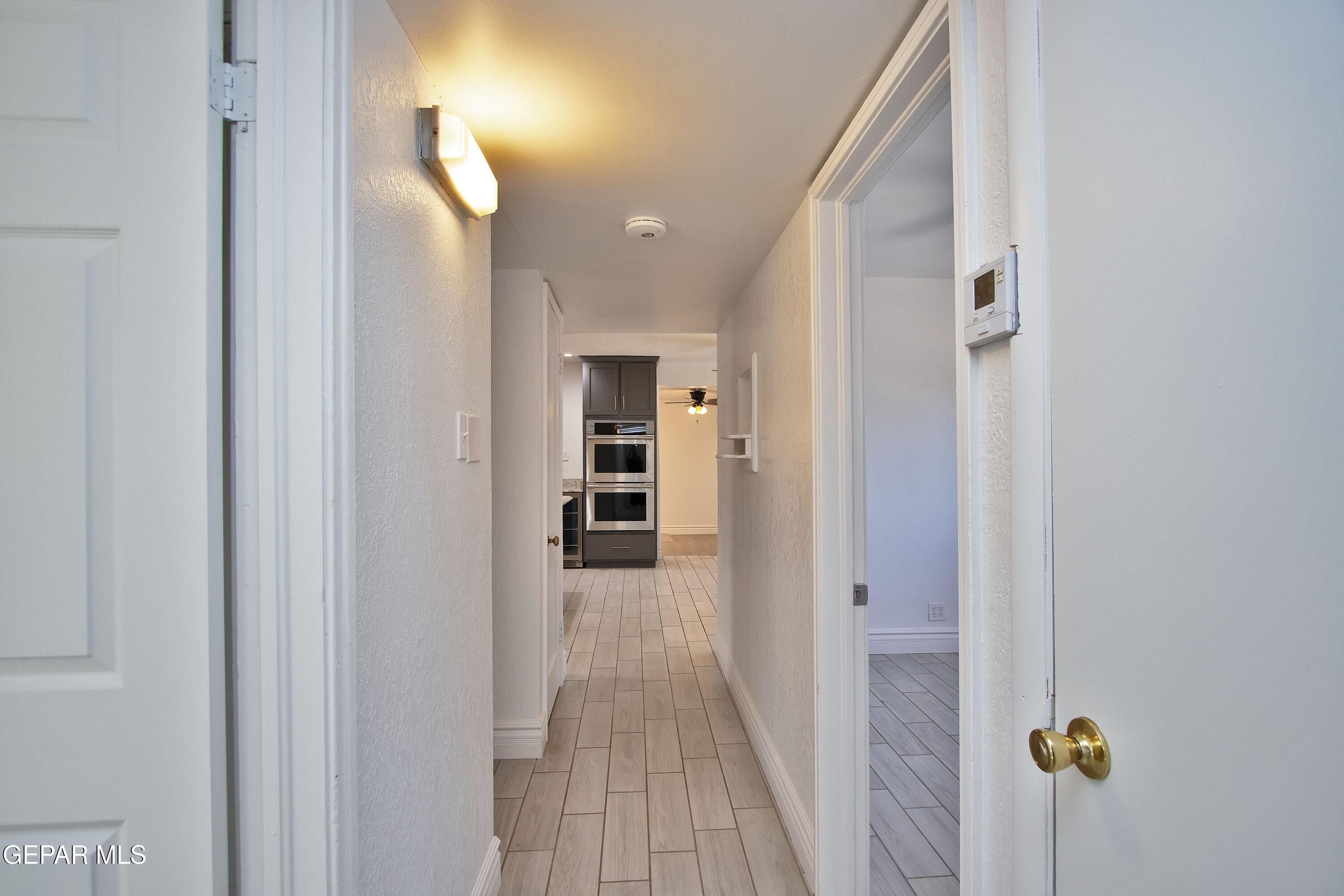 8415 Mt Ranier Drive El Paso, TX 79904 - Photo 43 of 69 a view of a hallway with wooden floor