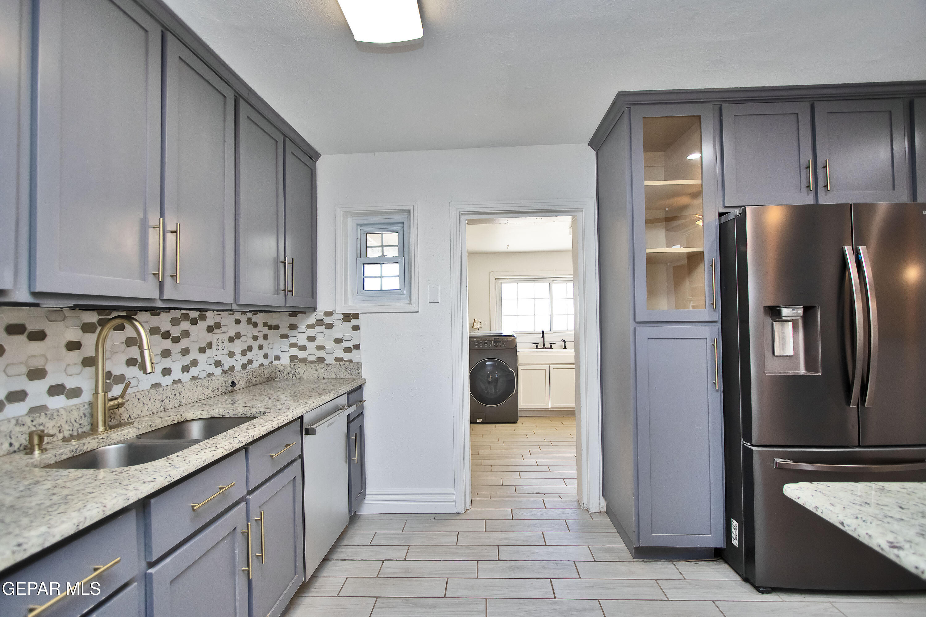 8415 Mt Ranier Drive El Paso, TX 79904 - Photo 44 of 69 a kitchen with stainless steel appliances granite countertop a refrigerator and a sink