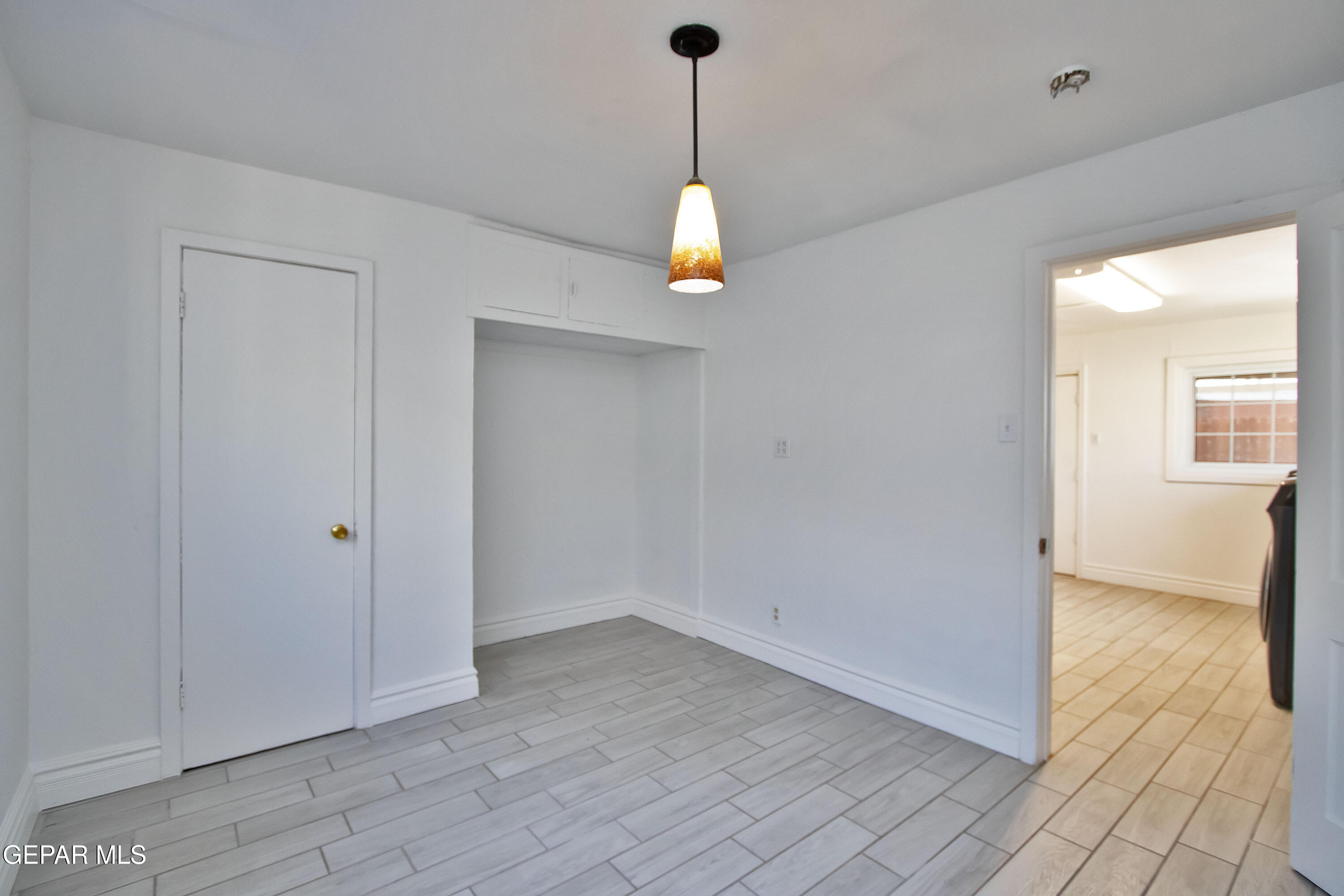 8415 Mt Ranier Drive El Paso, TX 79904 - Photo 51 of 69 wooden floor in an empty room with a window