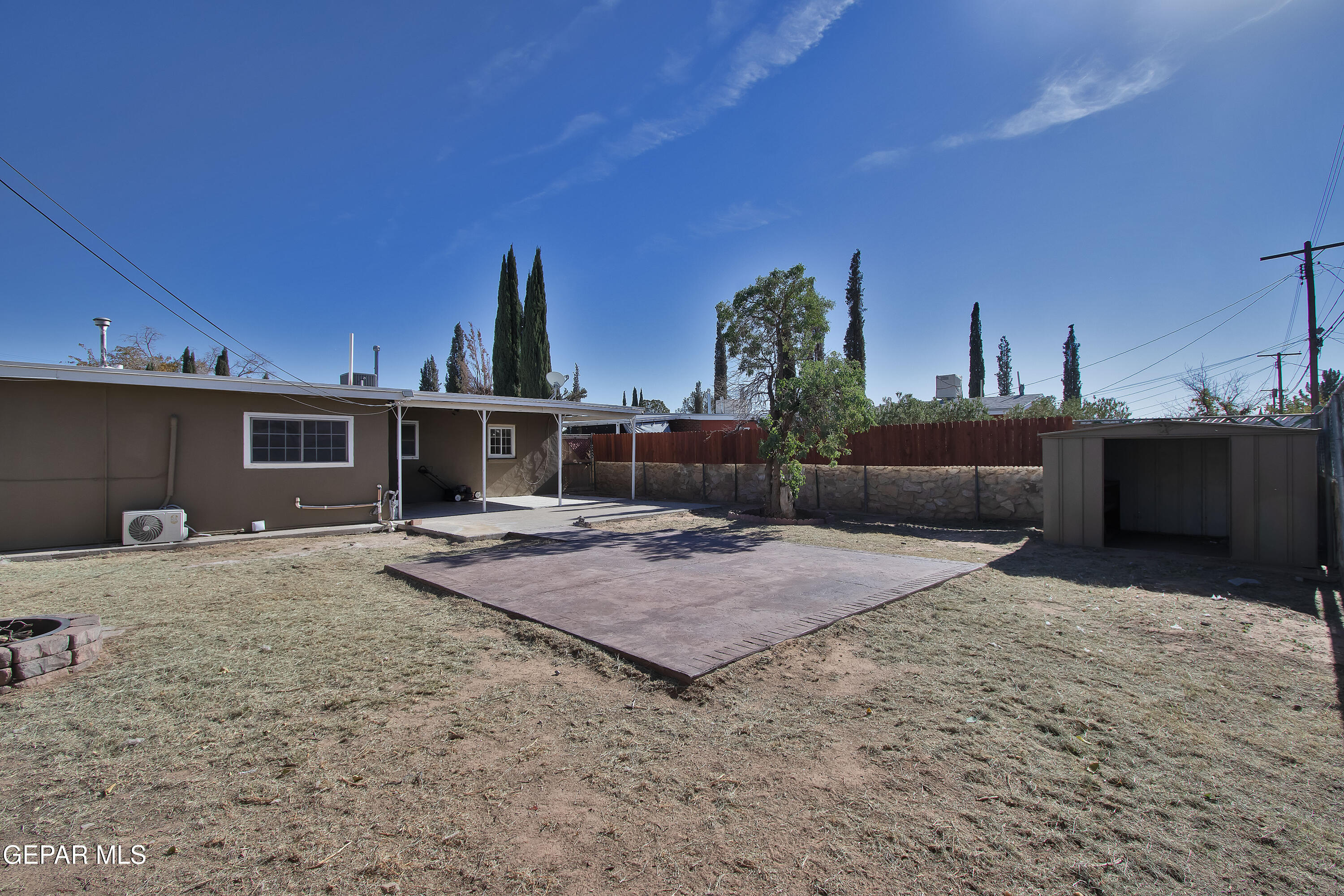8415 Mt Ranier Drive El Paso, TX 79904 - Photo 63 of 69 a backyard of a house with barbeque oven and outdoor seating