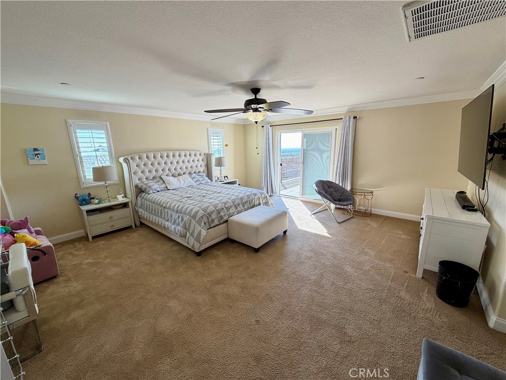 13538 Applegate Court Rancho Cucamonga, CA 91739 - Photo 14 of 30 a bedroom with a bed a couch and a flat tv screen on the dresser