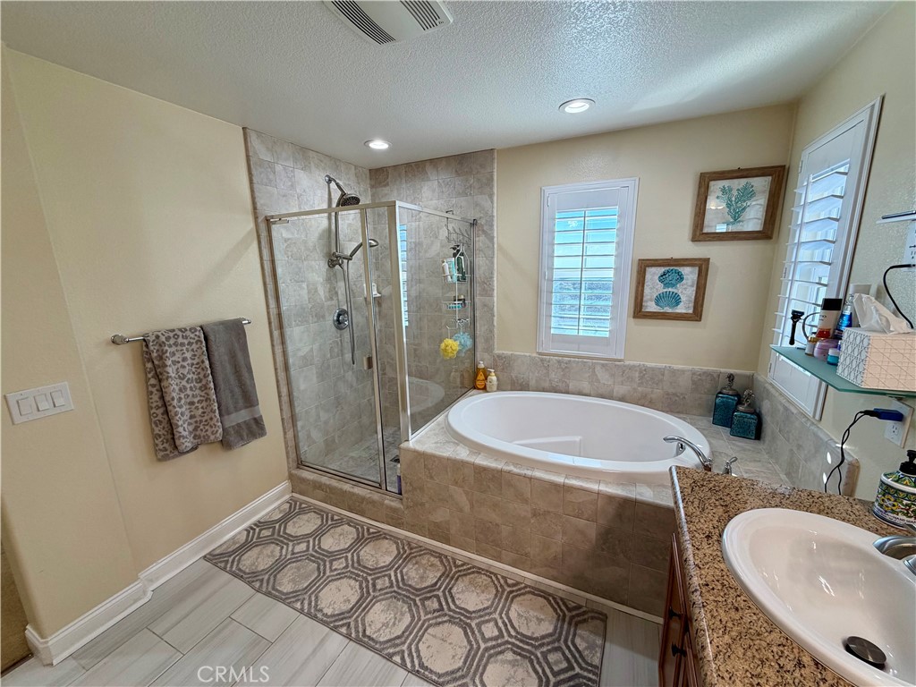 13538 Applegate Court Rancho Cucamonga, CA 91739 - Photo 17 of 30 a bathroom with a sink a toilet a shower a mirror and bathtub