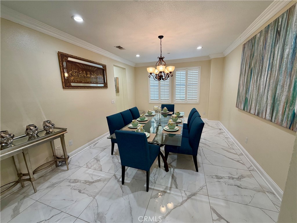 13538 Applegate Court Rancho Cucamonga, CA 91739 - Photo 4 of 30 a dining room with furniture and chandelier