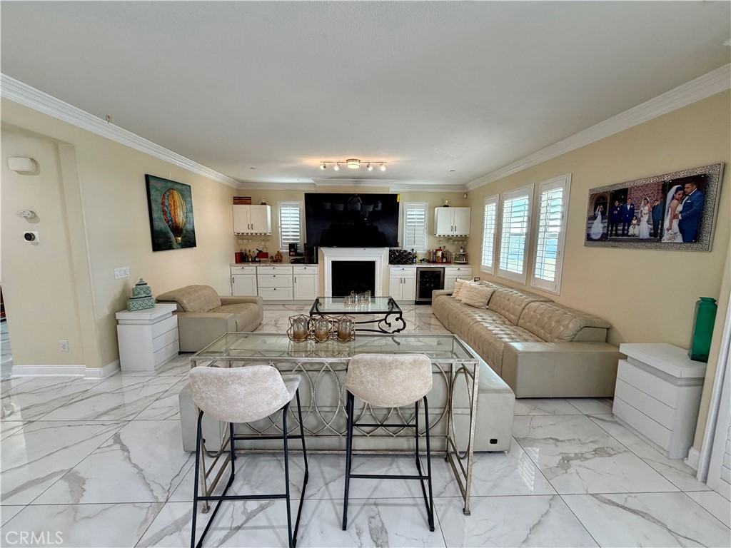 13538 Applegate Court Rancho Cucamonga, CA 91739 - Photo 6 of 30 a living room with furniture a flat screen tv and a fireplace