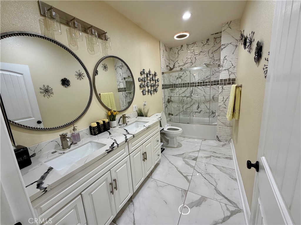 13538 Applegate Court Rancho Cucamonga, CA 91739 - Photo 9 of 30 a bathroom with a double vanity sink mirror and shower