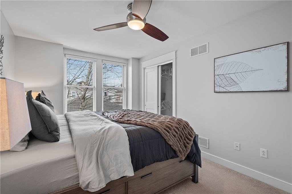 706 Ivy Street, Unit 2 Pittsburgh, PA 15232 - Photo 24 of 35 a bedroom with a bed and wooden floor