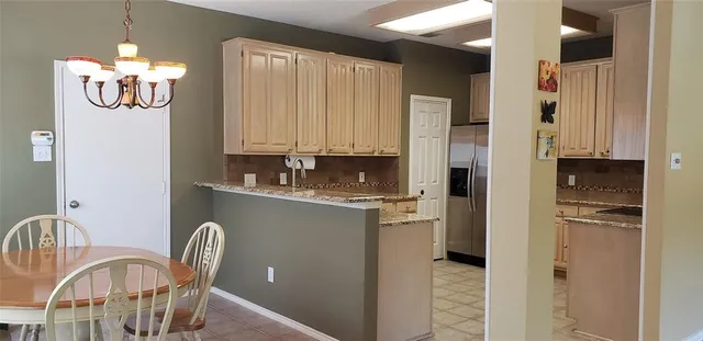 a kitchen with stainless steel appliances granite countertop a refrigerator and microwave