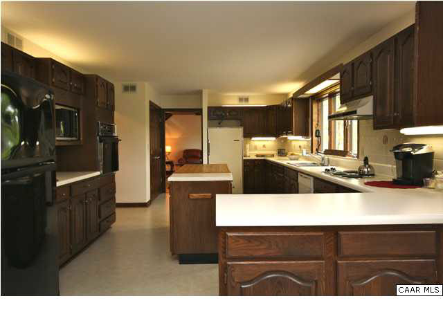 57 Laguna Road Palmyra, VA 22963 - Photo 13 of 32 a kitchen with a refrigerator and a stove top oven