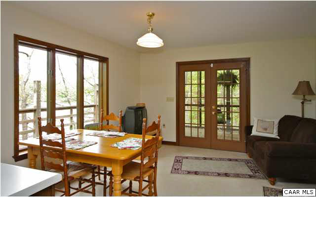 57 Laguna Road Palmyra, VA 22963 - Photo 14 of 32 a living room with furniture a window and a chandelier